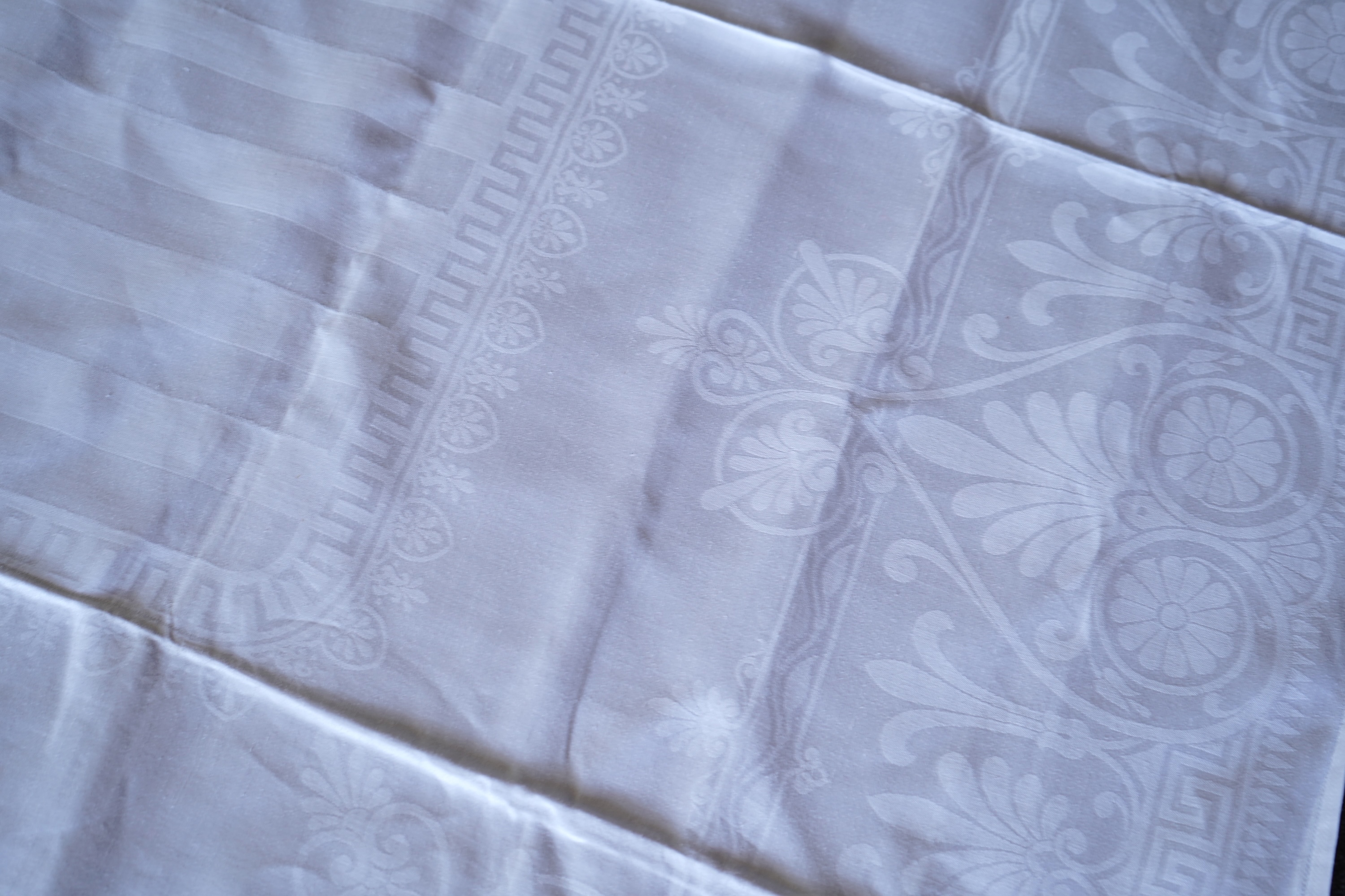 A late 19th century large white Irish damask table cloth, woven with an all over Christopher Dresser ‘inspired’ design. The overall design incorporating many of his known stylistic design motifs. Each corner has a shamro